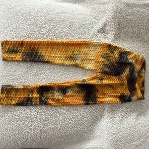 Orange and grey tie-dye stretchy yoga pants with a scrunch style on the butt.